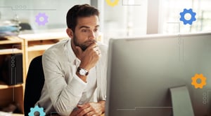 A person looking at a computer monitor.