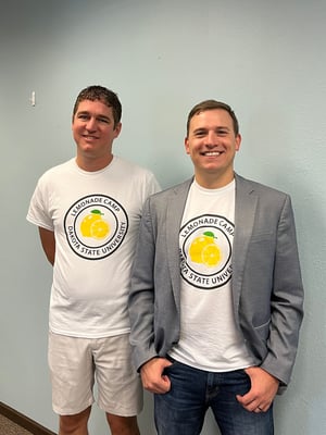 Chad Knutson and Jon Waldman wearing Lemonade Camp shirts.